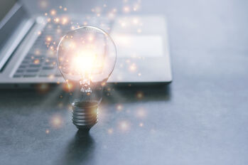 Laptop and glowing light bulb. Self learning or education knowledge and business studying concept. Idea of learning online or e-learning from home.