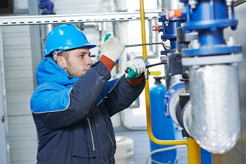 technician worker of heating system in boiler room installation